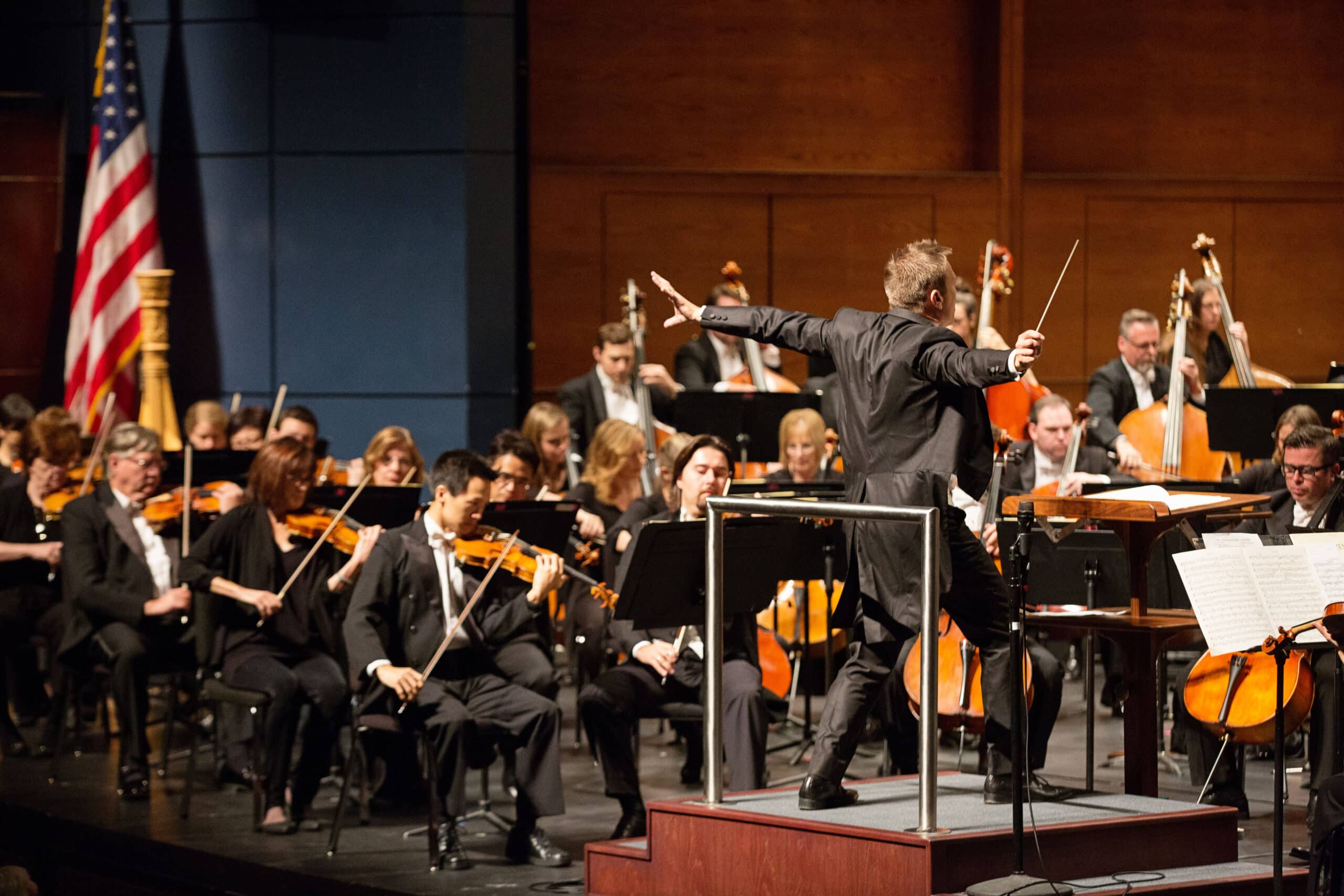 The Oklahoma Philharmonic is shown enthusiastically performing.